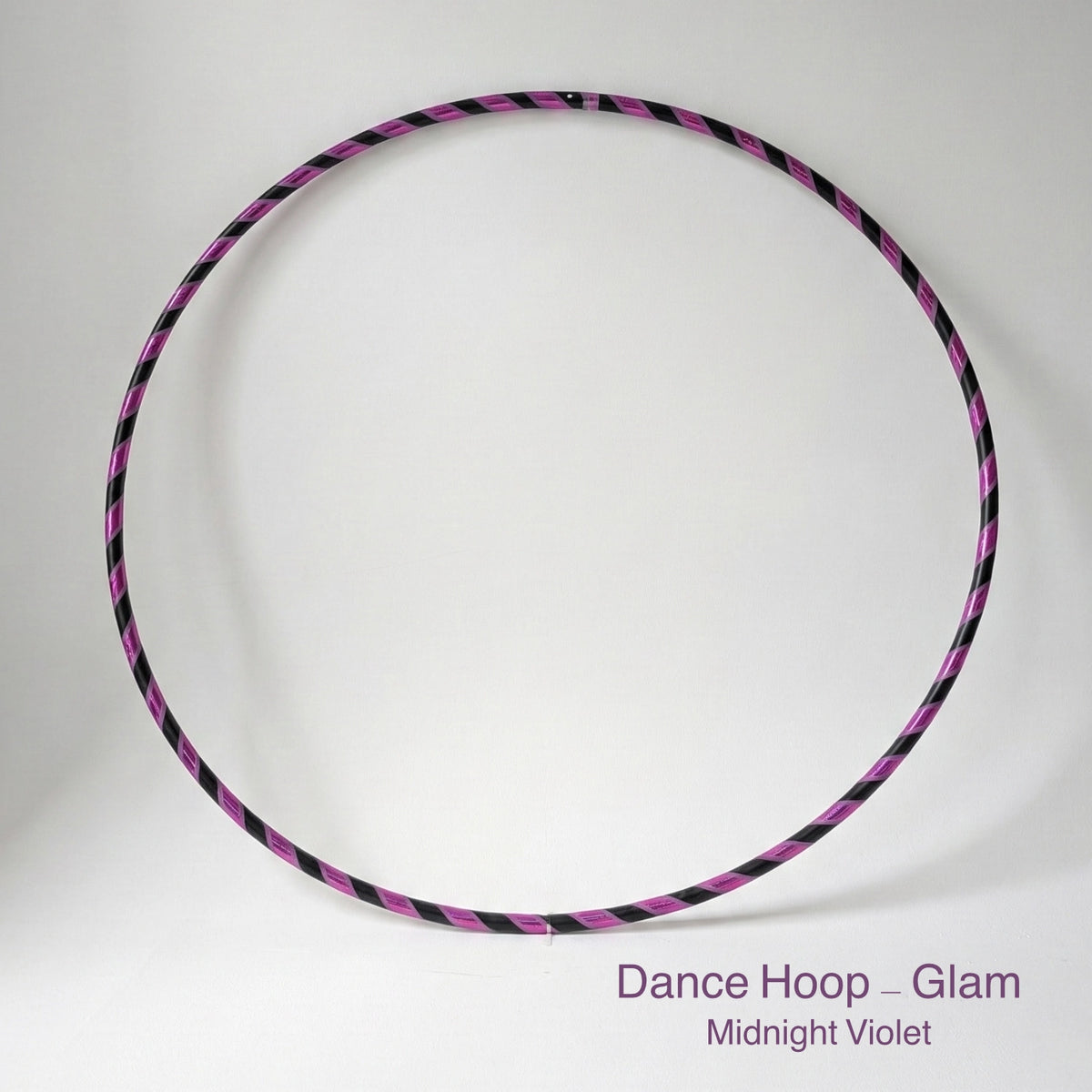 Dance hula hoop – Midnight Violet Glam Edition. Professional black tubing featuring a reflective purple mirror and grip tape spiral design for dance and fitness.