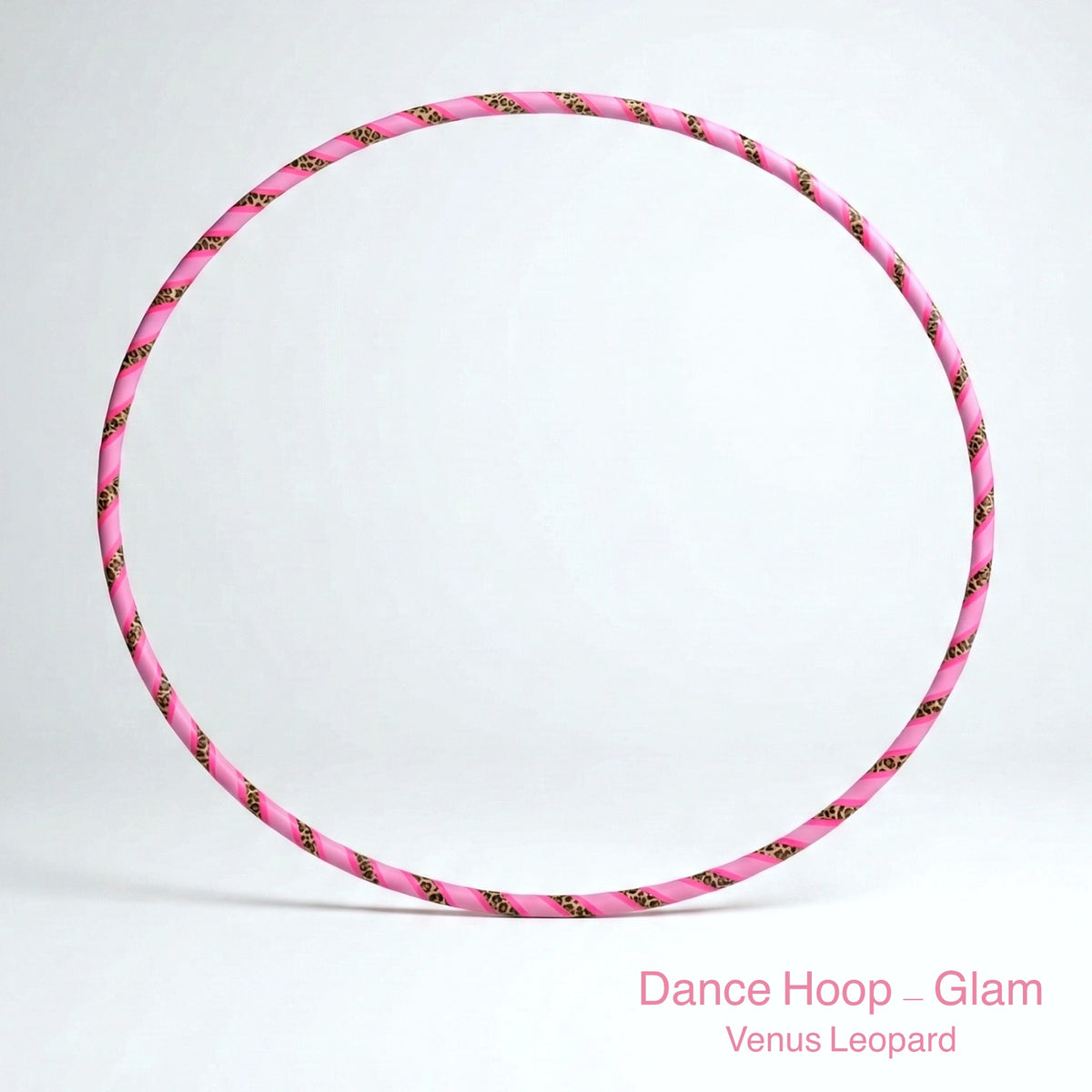 A professional Dance Hoop – Glam in the Venus Leopard style, featuring a vibrant pink and leopard print spiral tape pattern. The hoop is set against a minimalist white background. Text at the bottom right corner reads: Dance Hoop – Glam Venus Leopard.