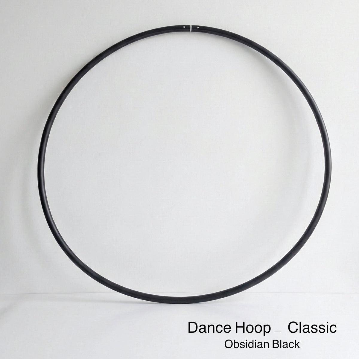 Dance Hula Hoop - Classic Edition in Obsidian Black. High-quality untaped professional hula hoop for dance and fitness.