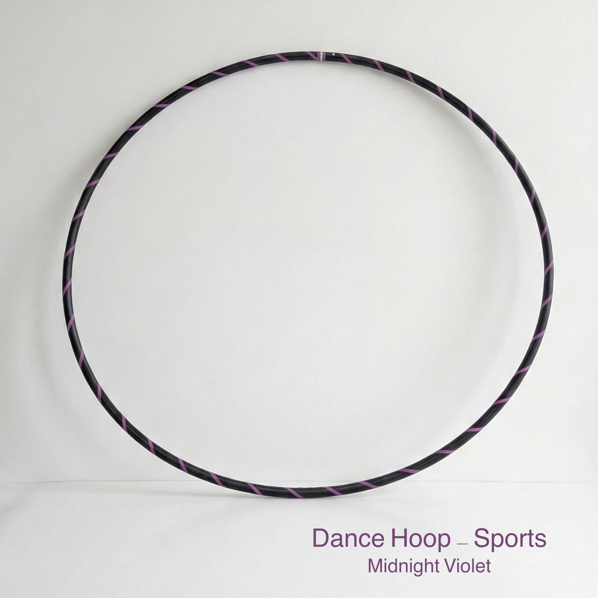 Dance hula hoop – Midnight Violet Sports Edition. Professional black tubing featuring a sleek purple spiral tape design for dance and fitness.