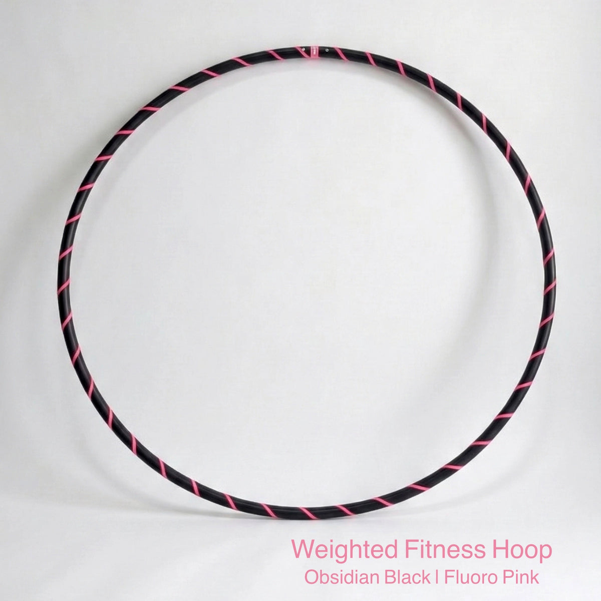 Weighted fitness hula hoop for adults in Obsidian Black sports model, featuring professional black tubing with a sleek fluoro pink spiral tape design.