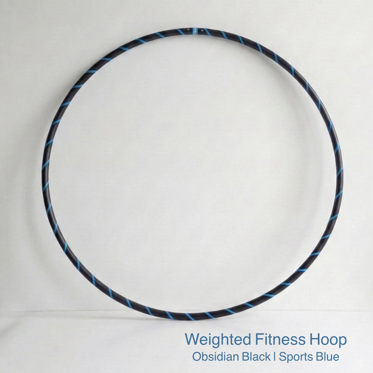 Weighted fitness hula hoop for adults in Obsidian Black sports model, featuring professional black tubing with a sleek fluoro blue spiral tape design.