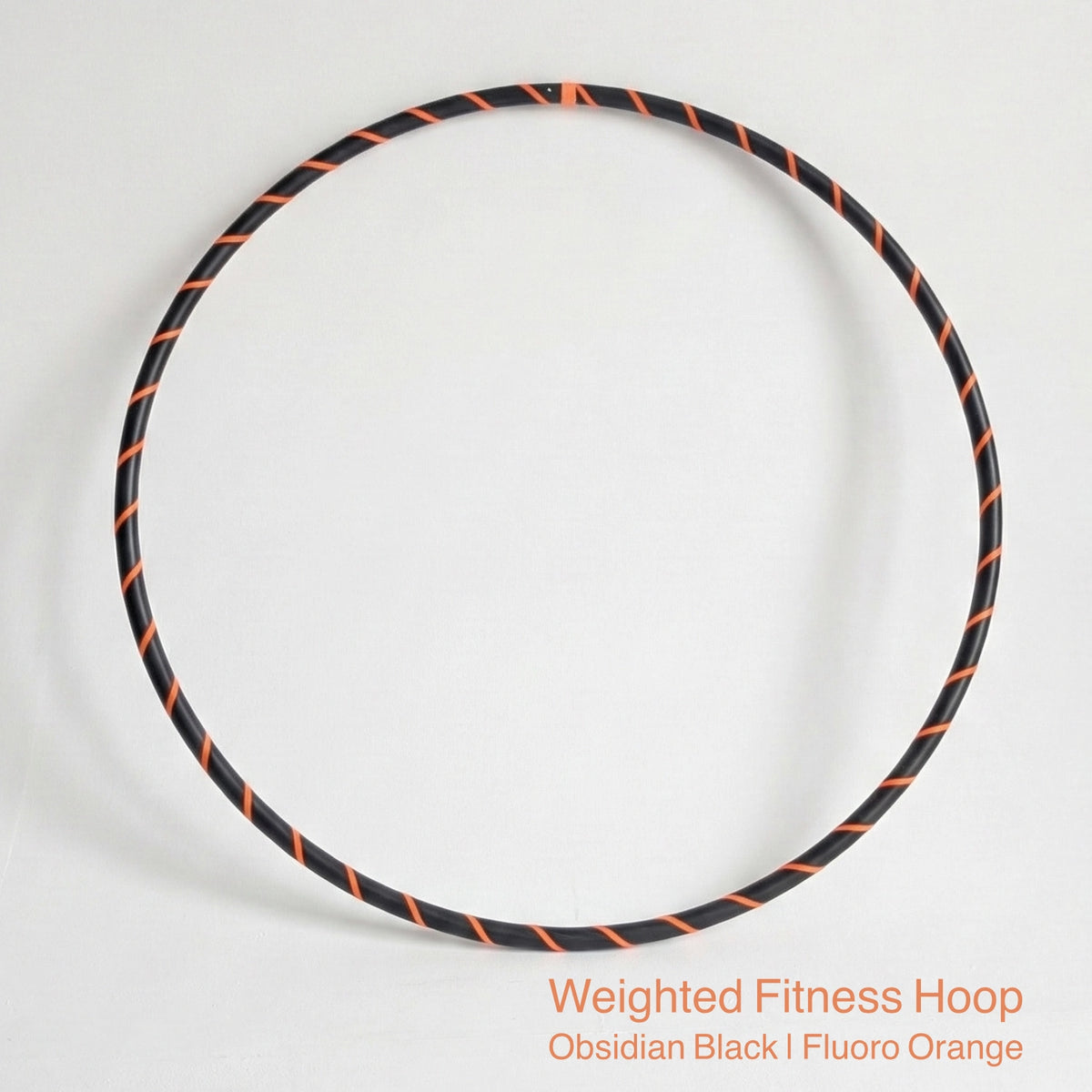 Weighted fitness hula hoop for adults in Obsidian Black sports model, featuring professional black tubing with a sleek fluoro orange spiral tape design.