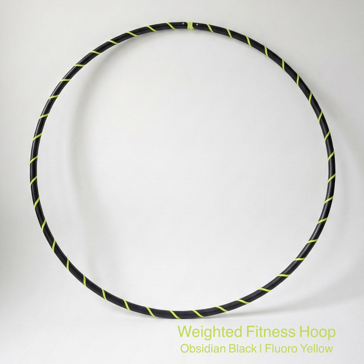 Weighted fitness hula hoop for adults in Obsidian Black sports model, featuring professional black tubing with a sleek fluoro yellow spiral tape design.